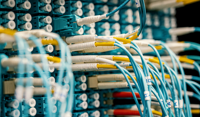 Network assessment fiber optic cables connected to IT infrastructure equipment.