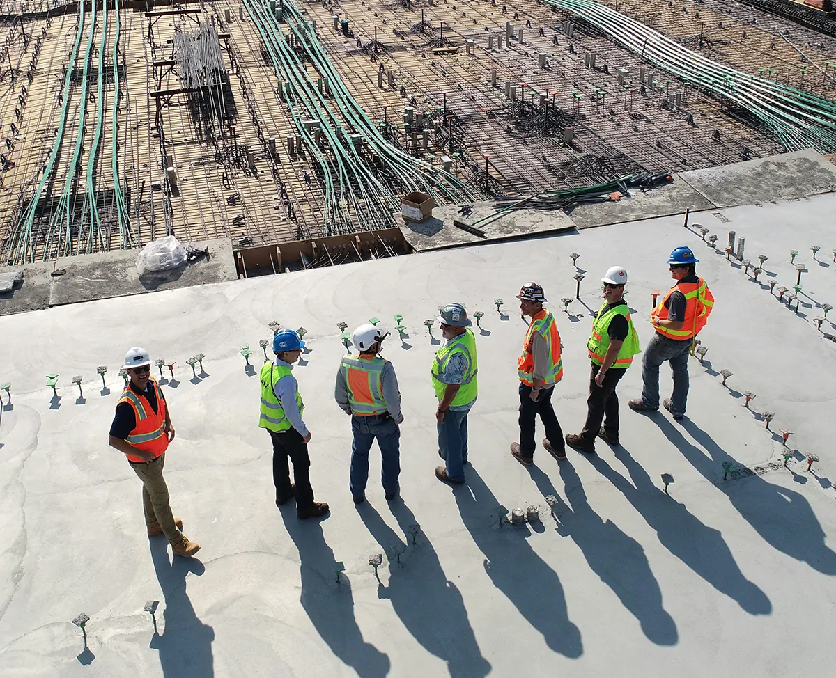 construction-site-it-project-team Construction workers and project managers reviewing infrastructure on a commercial job site