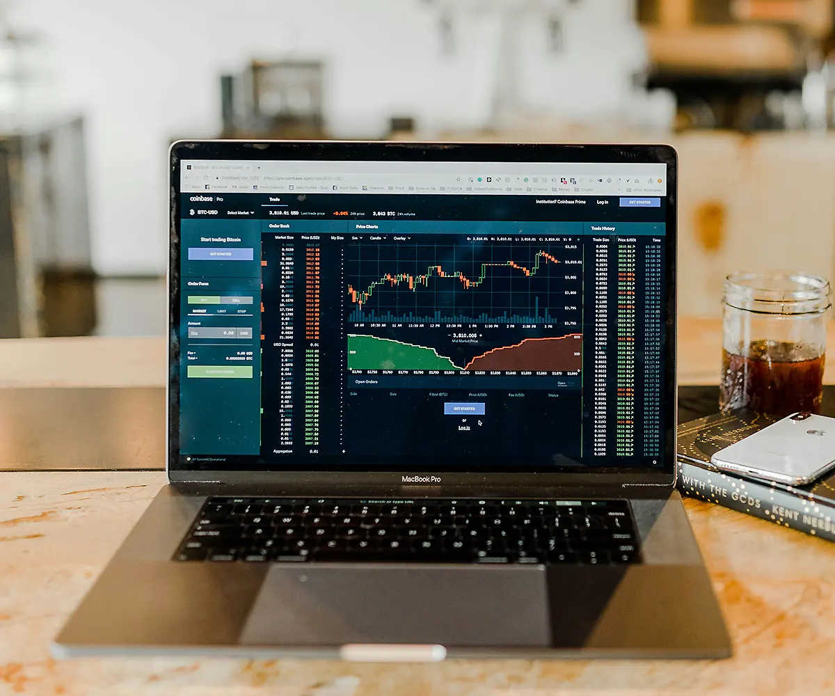 financial-data-dashboard-on-laptop Cryptocurrency trading dashboard on MacBook for financial data analysis in fintech environment