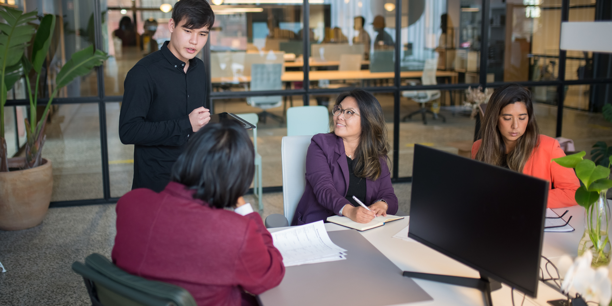 Consulting team in strategy meeting to plan enterprise network management solutions