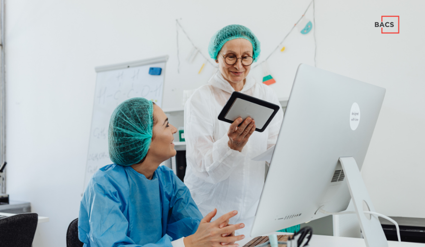 Lab staff reviewing IT infrastructure for biotech startups at a computer workstation