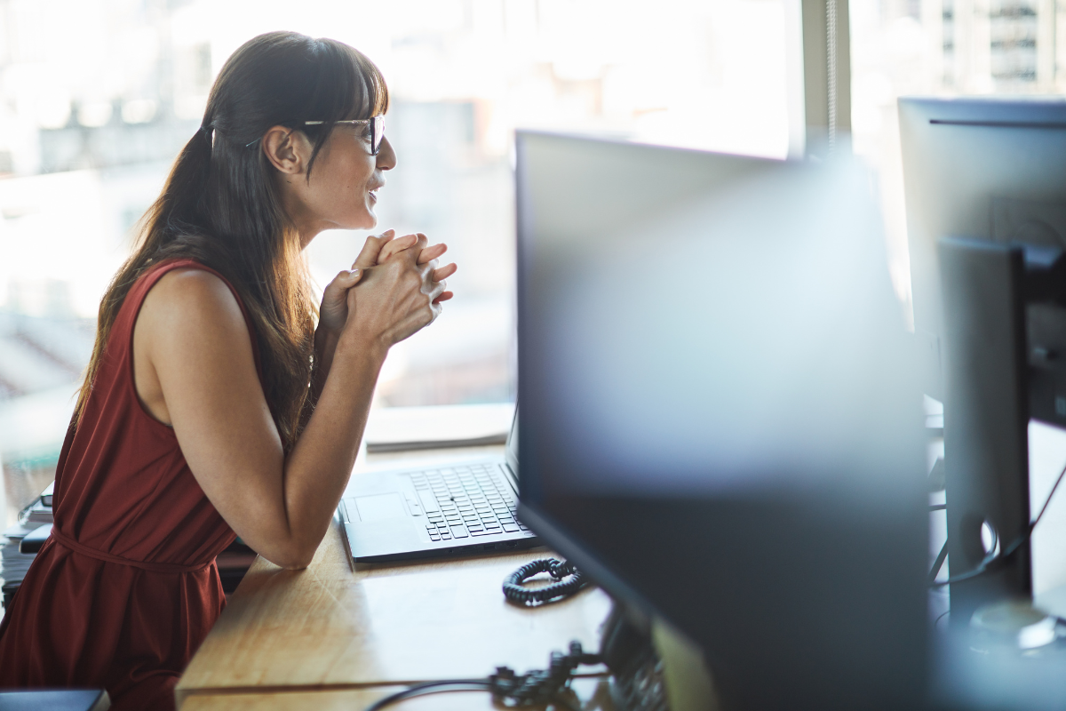 Claude AI for business productivity showing a professional using AI tools at a computer workstation
