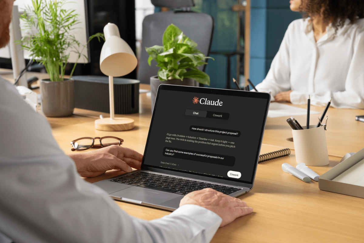 Claude AI consulting showing a business professional using Claude AI on a laptop in a workplace setting